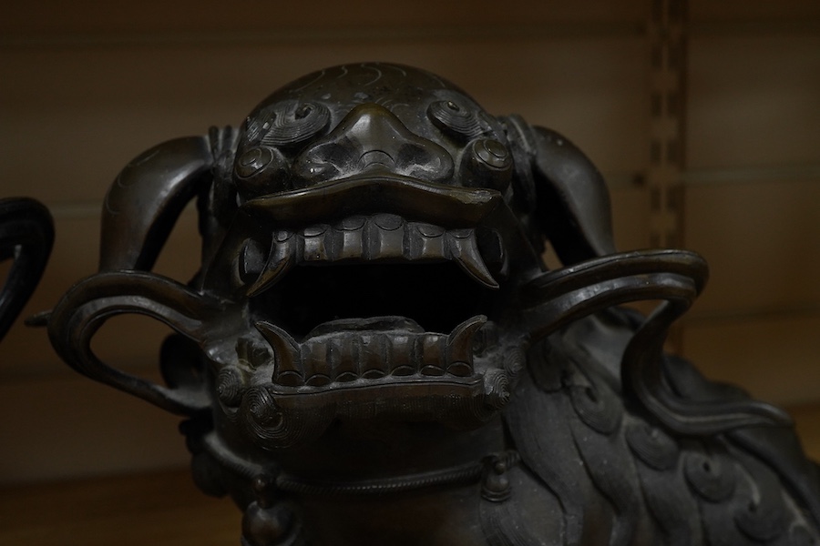 A pair of large 19th century Chinese bronze lion dogs, 26cm